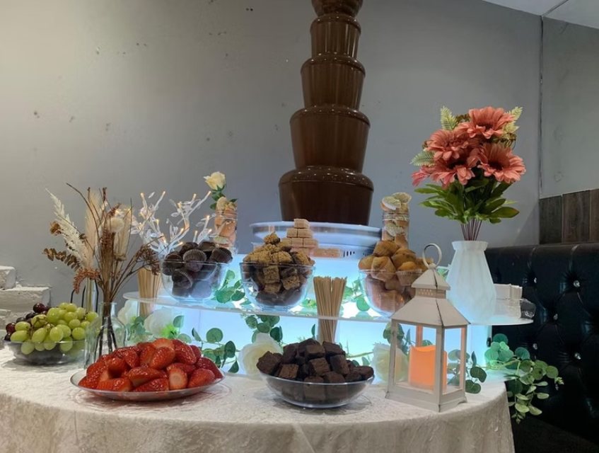 Chocolate fountain and dessert table with strawberries, brownies and pastries at a Zaiqa London event