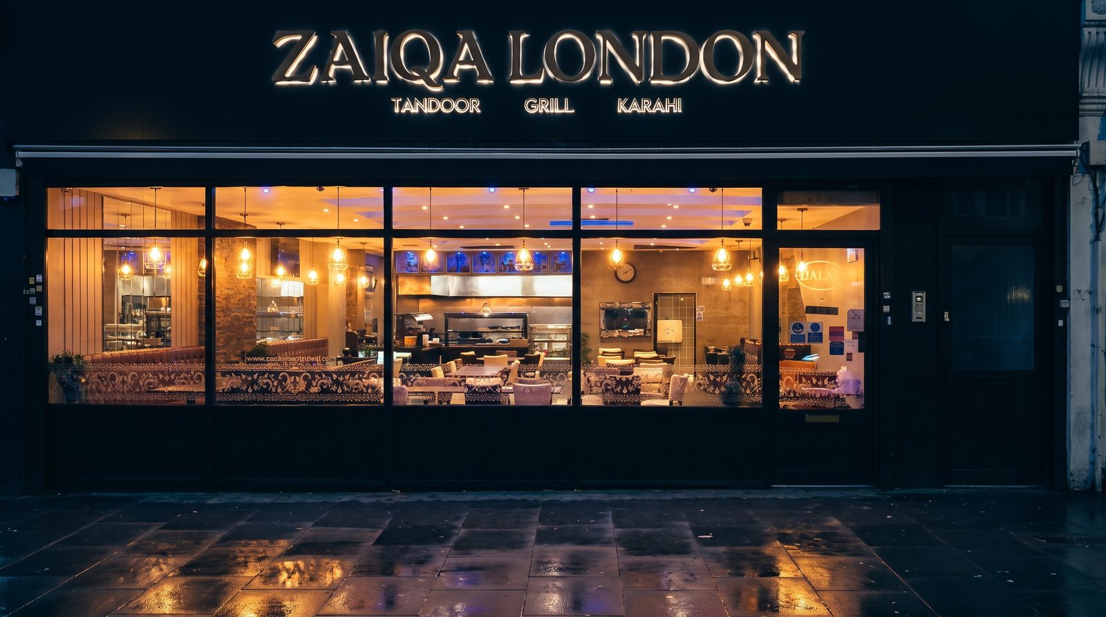 Zaiqa London's tandoor, grill and karahi kitchen lit up at night on Whitechapel Road