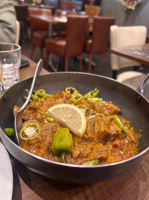 Lamb karahi served in the iron pan with green chilli and lemon at Zaiqa London