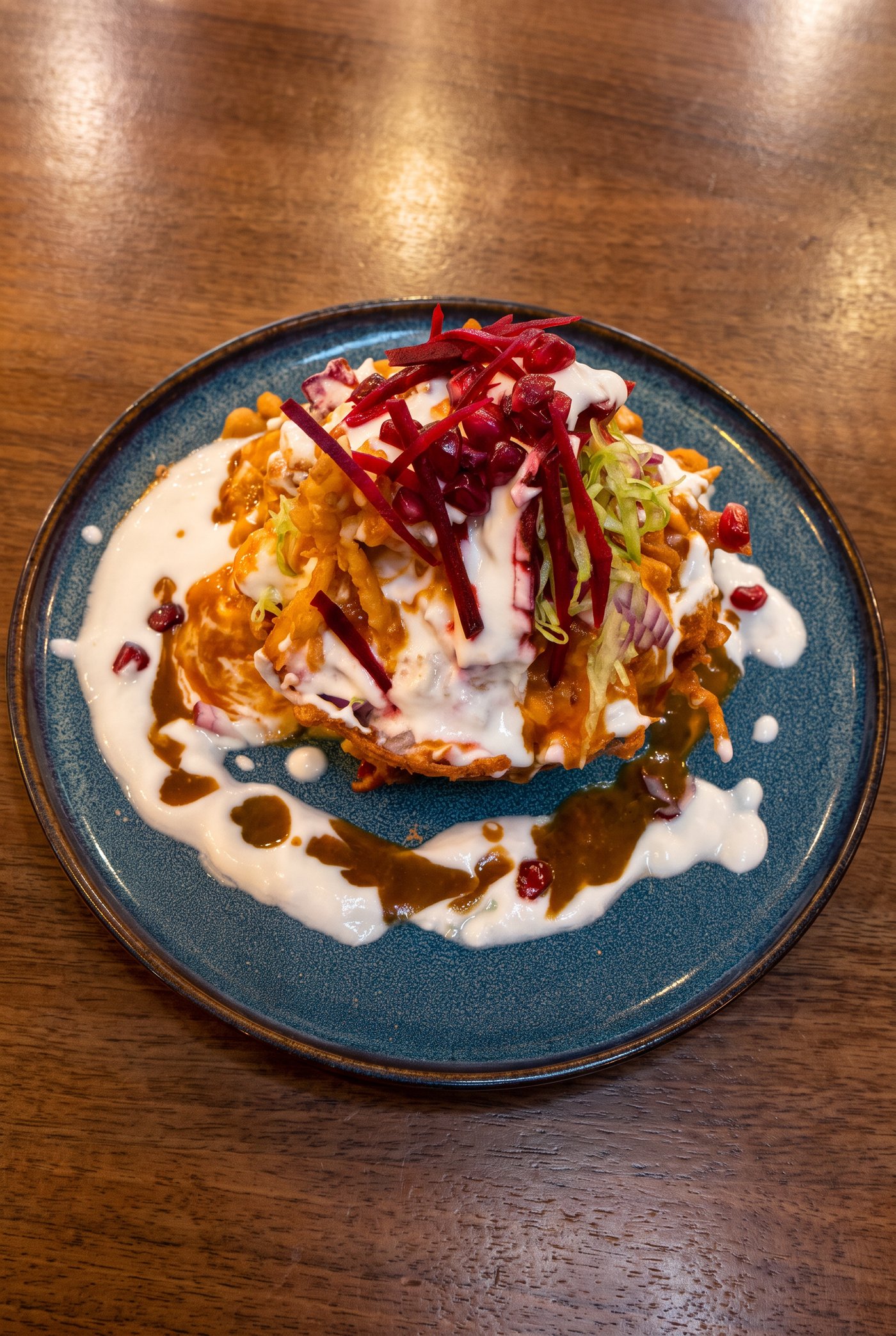 Samosa chaat, topped with yoghurt, tamarind and pomegranate at Zaiqa London